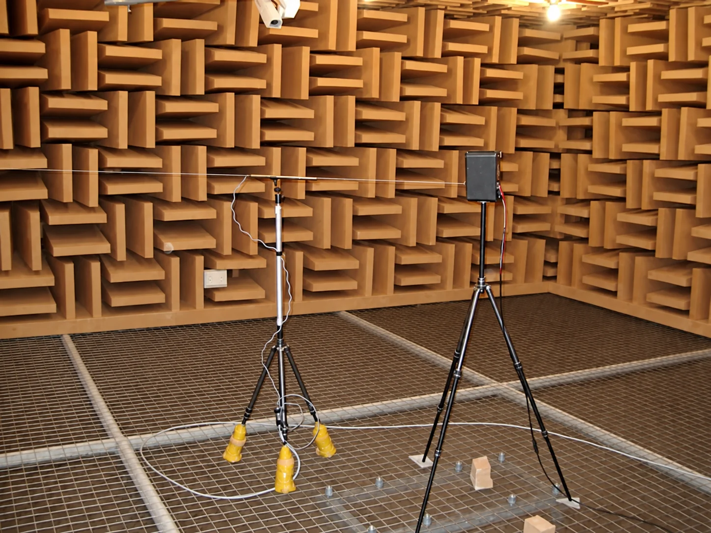 Anechoic chamber interior with acoustic wedges, mesh floor and measurement equipment