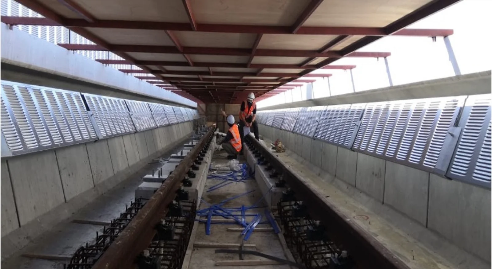 Noise barrier installation work beside the LRT3 tracks
